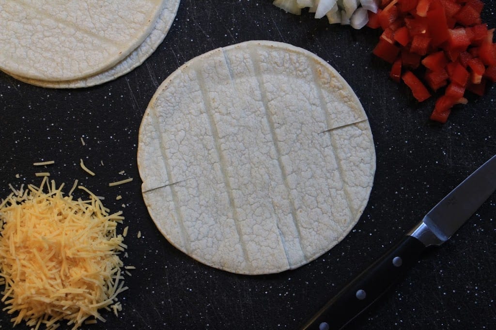 Make four, one-inch slits in the tortillas