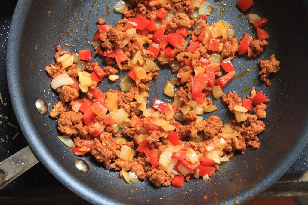 Sauté the bell pepper, onion, and chorizo in a skillet