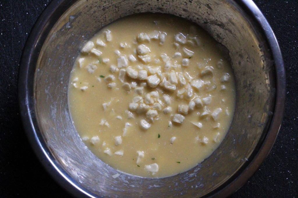 In a medium bowl, whisk together egg, butter, water, corn and vanilla