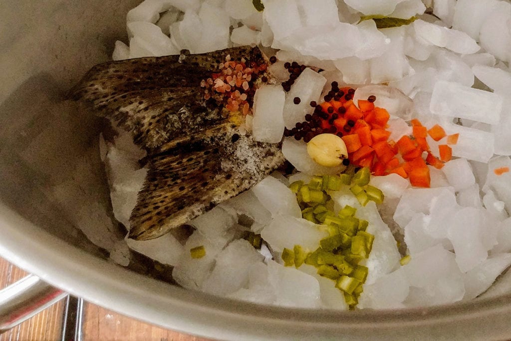 Cover fish bones and aromatics with ice, then gently heated to create the fumet