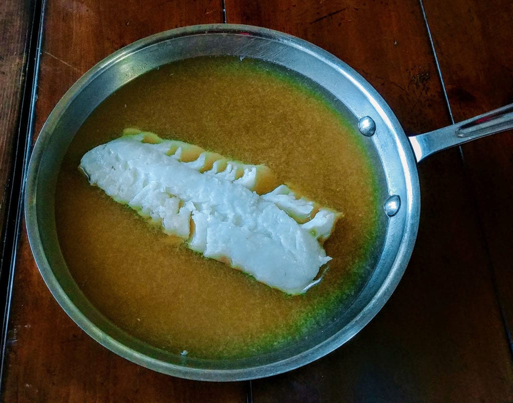 Gently poach the fish in bouillon until just done