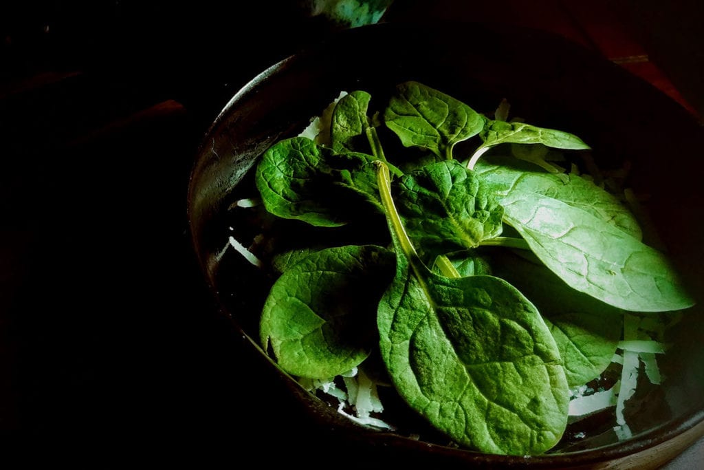 A layer of baby spinach leaves adds bright color and freshness.