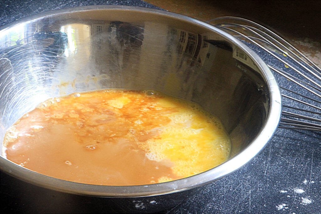 In a medium bowl, mix together eggs, milk, butter and vanilla extract