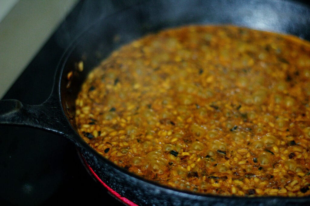 Add half of the carrot juice and adjust heat to a slow simmer, stirring every few minutes until absorbed, then add a ladle more at a time over 15 minutes until each ladle is absorbed.