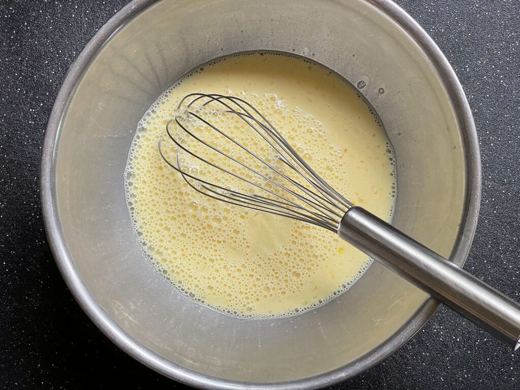 Mix the eggs, sugar and milk for Tahoma Meadow's Mökki Pannukakku