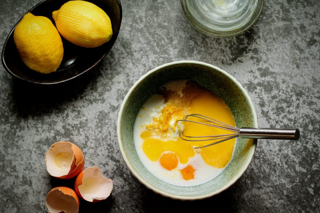 Whisk together wet ingredients, sugar, and lemon zest until smooth.