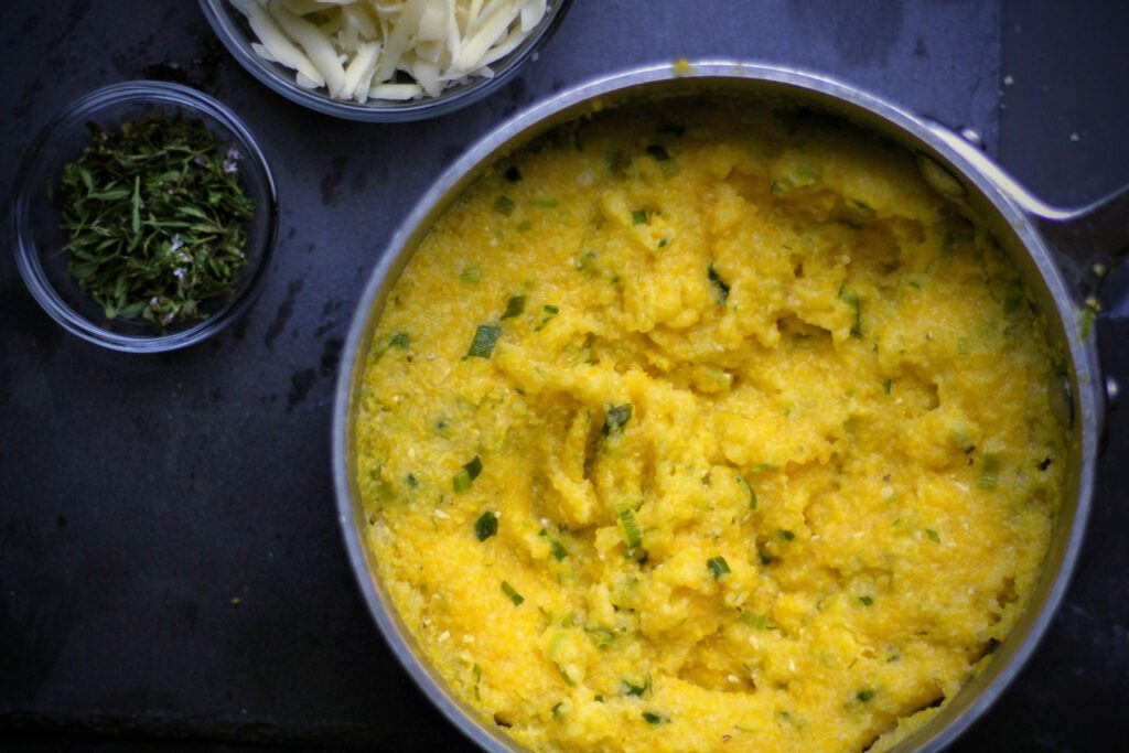 Cook polenta until creamy, then stir in cheese and thyme