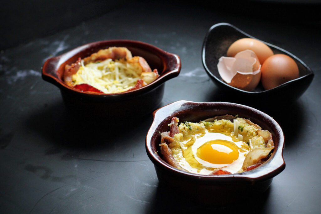 Line ramekins with bacon, fill with polenta and more cheese, then crack an egg on top.