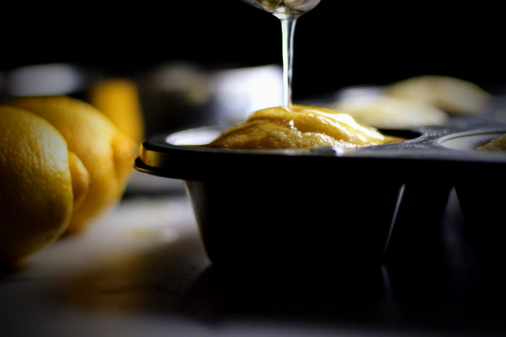 Spoon the lemon syrup over the muffins while they are still warm.