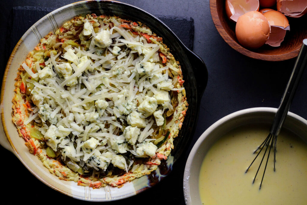 Leeks, onions, and cheese layered over cooked hash browns