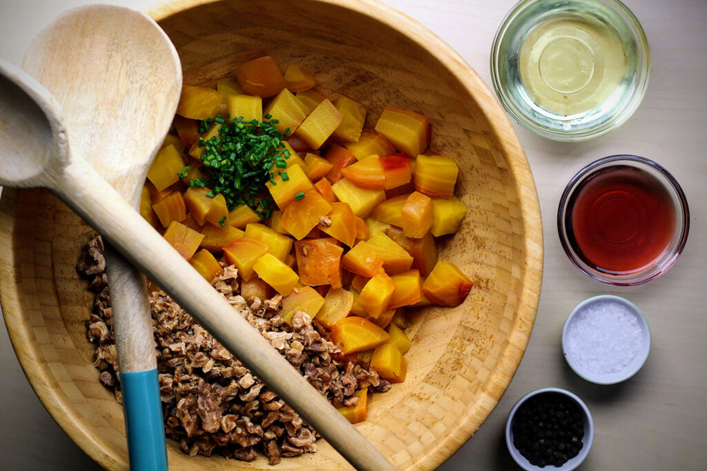 Toss golden beets with vinegar, oil, walnuts, chives, salt, and pepper.