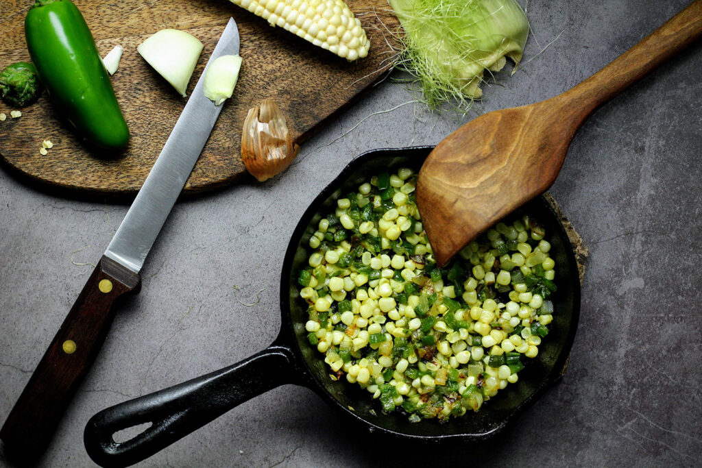 Sauté onions, chiles, and corn until caramelized.