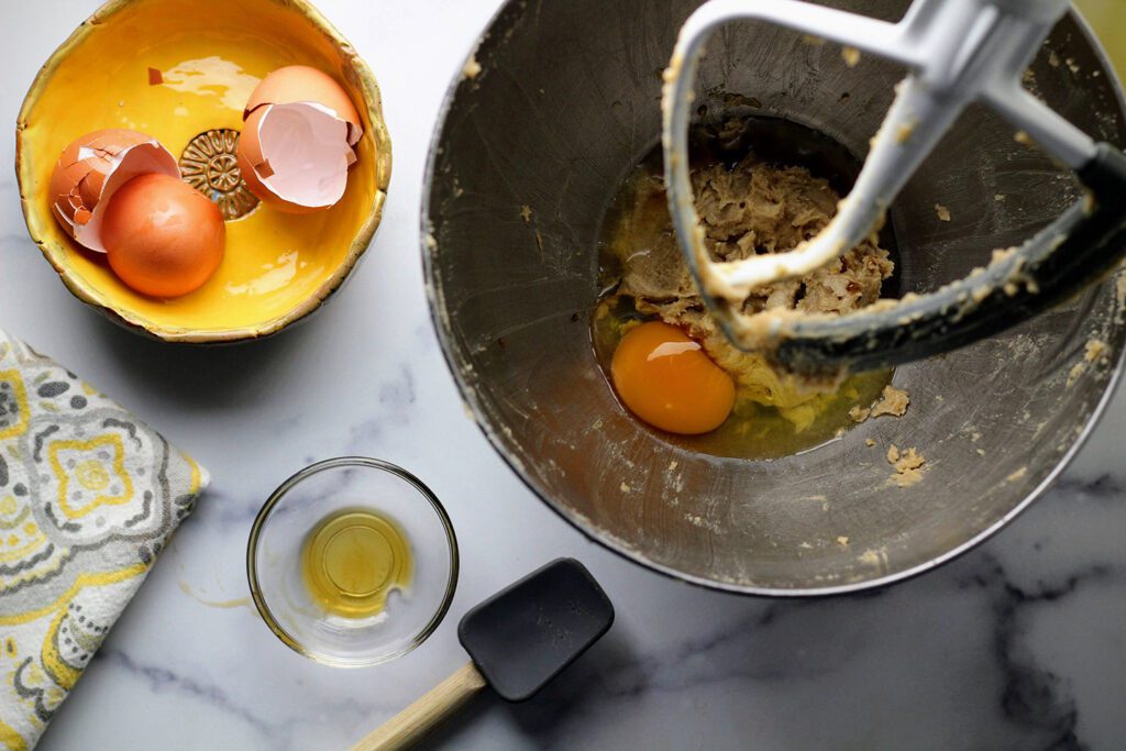 Cream butter with brown and white sugars until creamy, then add eggs and vanilla and beat well.