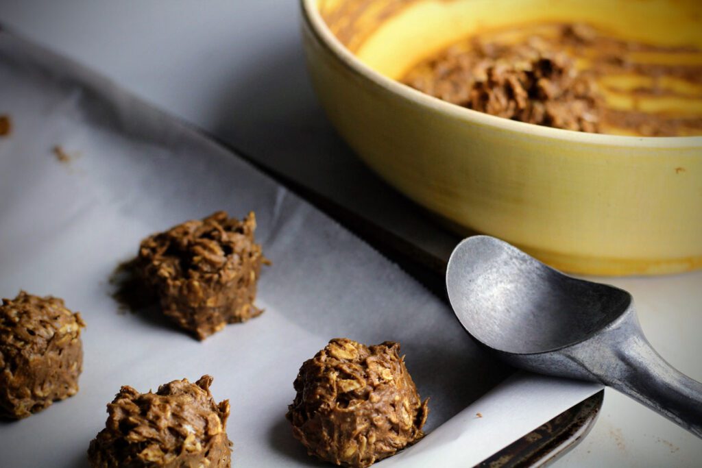 Scoop onto a parchment-lined baking sheet and bake at 350 degrees Fahrenheit for about 12 minutes.