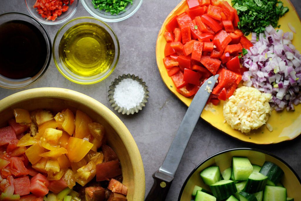 To make the gazpacho, chop the ingredients, combine, and marinate for 15 minutes.