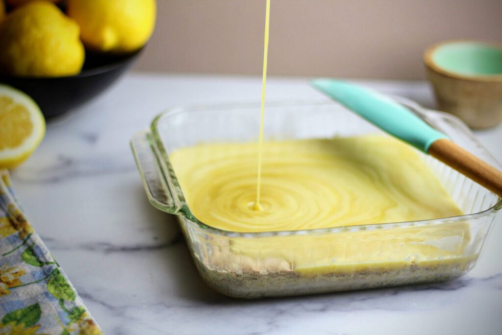 Pour the lemon bar filling onto the hot crust and bake until set