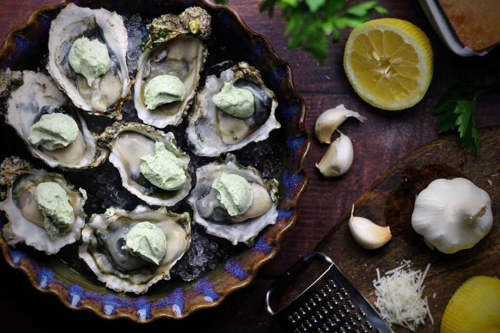 Top each oyster with a spoonful of garlic butter before grilling.