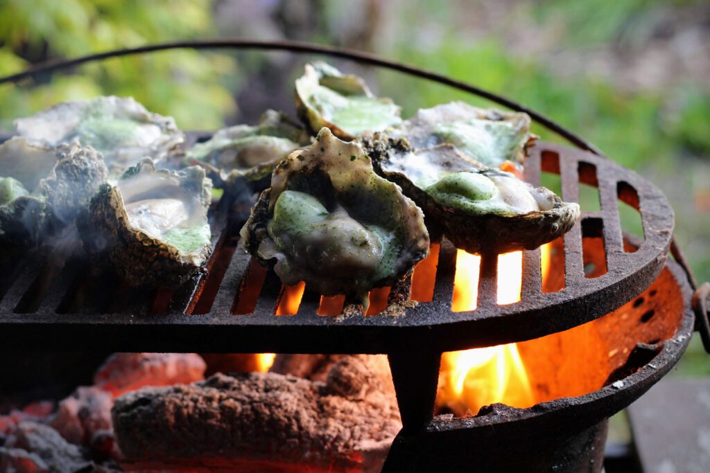 Grill oysters for three to five minutes, then garnish with lemon zest.