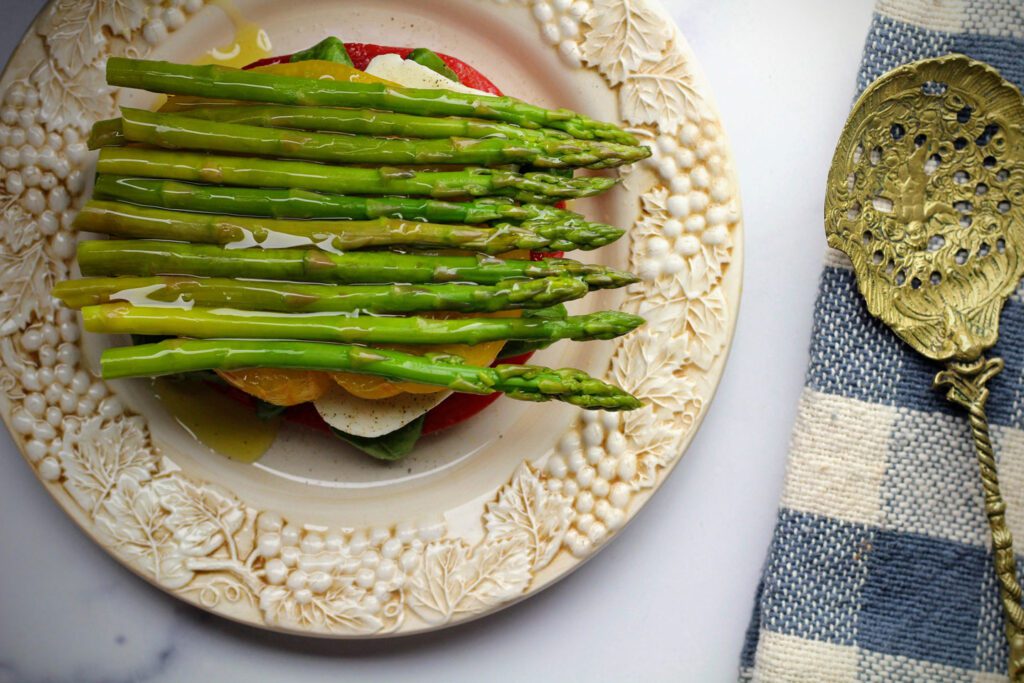 Asparagus spears stacked on mozzerella and tomato