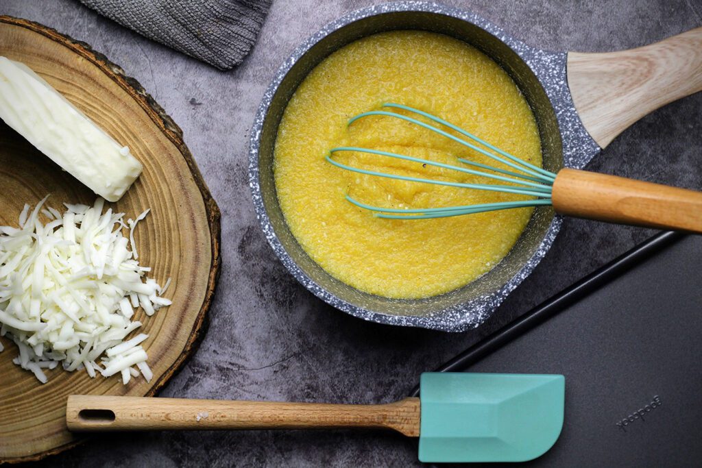 polenta cooked in chicken stock with shredded cheese on the side