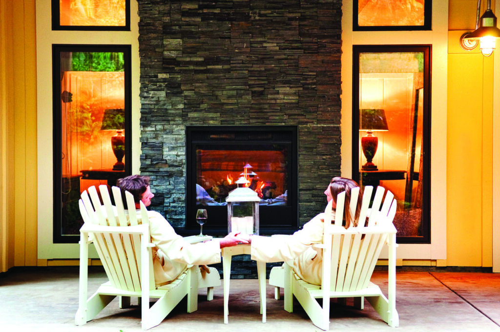 Barn Suite patio with an indoor/outdoor fireplace at Farmhouse Inn