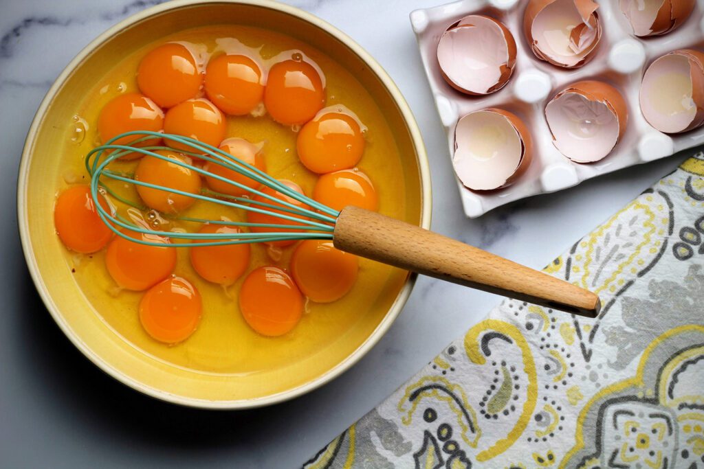 Beat eggs and yolks together in a separate bowl.