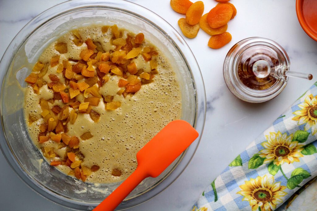 Folding dried apricots into the batter