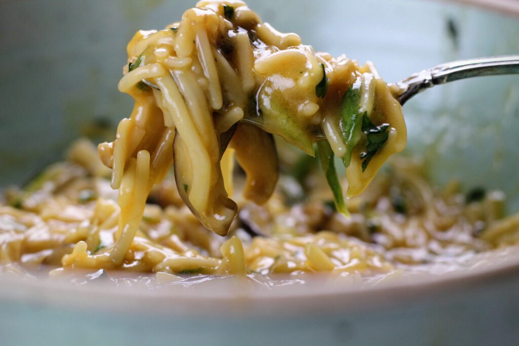 Close up of fork holding Sesame Somen Noodles with Shiitake Mushrooms