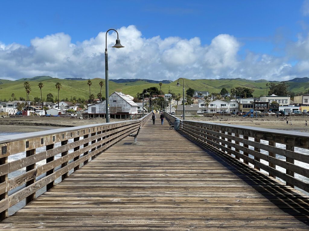 View of Cayucos and the rolling green hills above town from the historic pier.