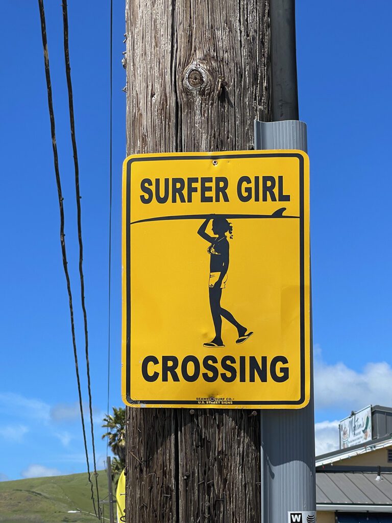 Surfer girl crossing sign in Caycuos