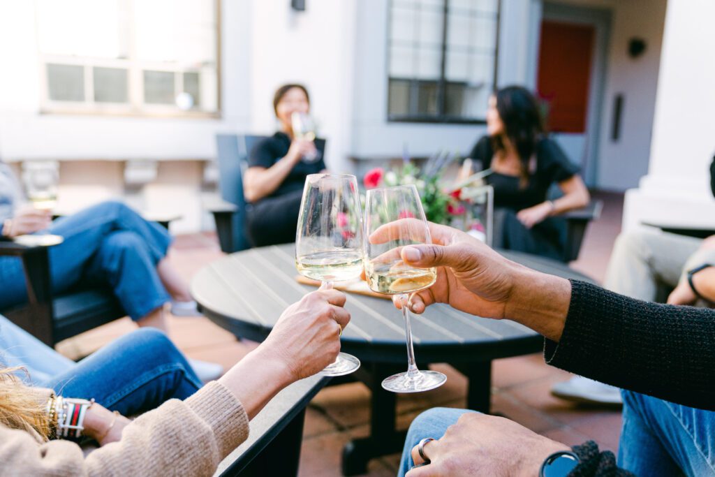 Friends sharing a white wine in the courtyard of the Atterdag Inn