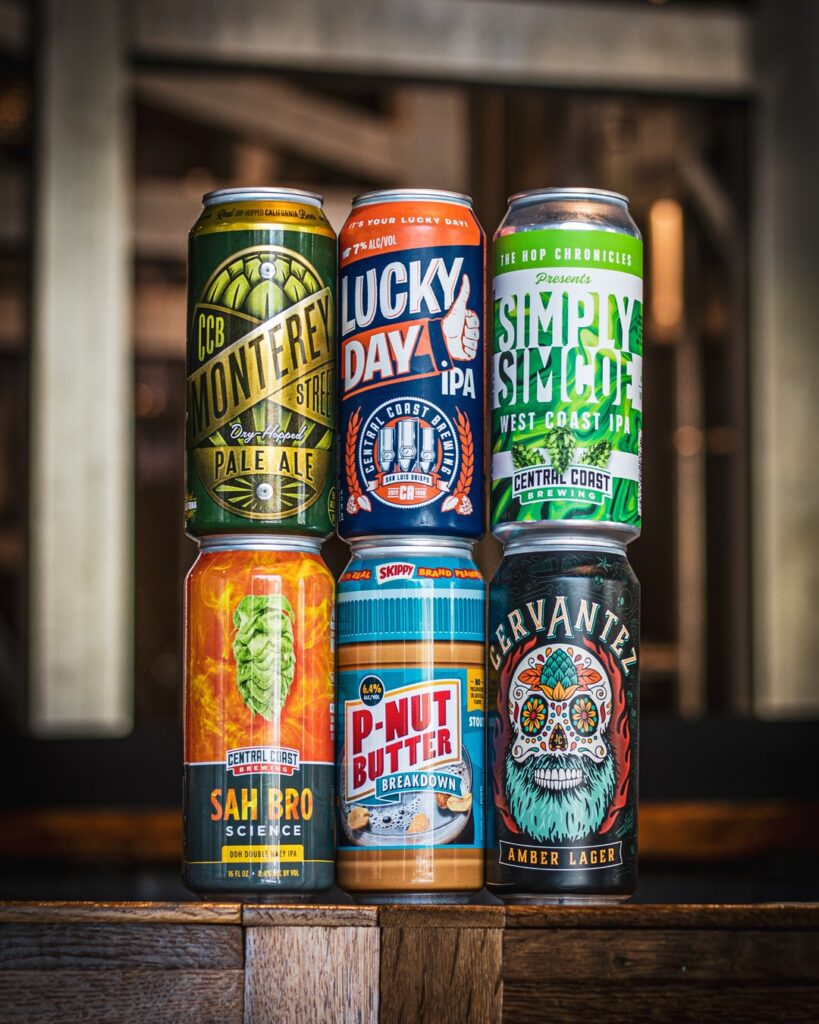 six unique beer cans lined up on a bar