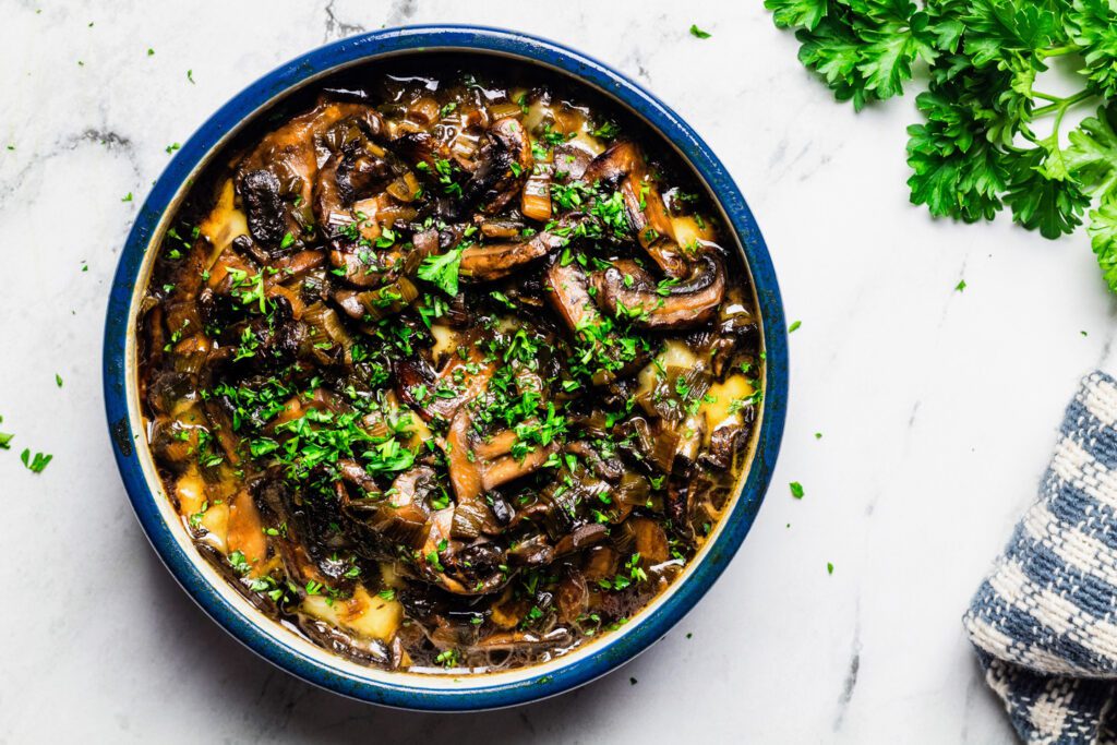 Baked bried and mushrooms topped with parsley