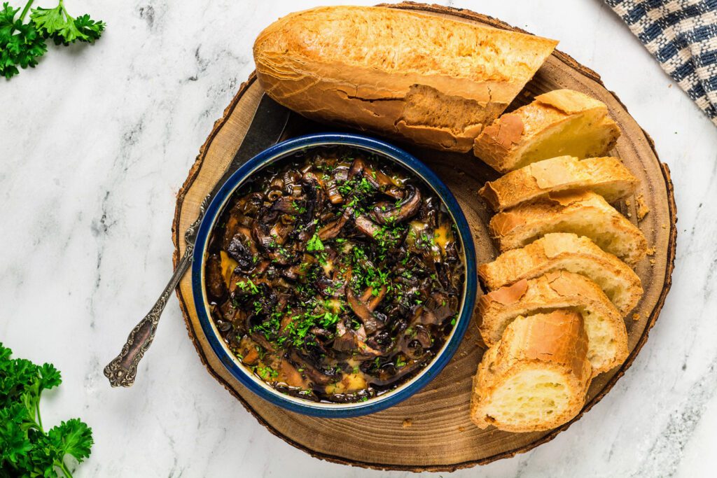 Baked brie with mushrooms and sliced baguette