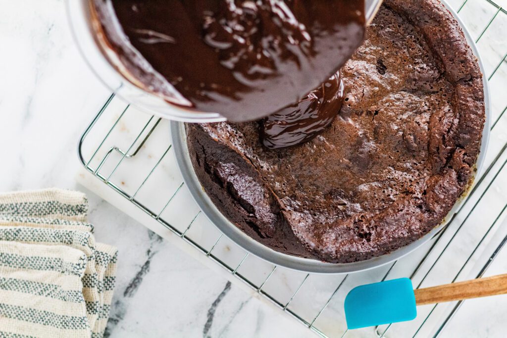 Stir hot cream into the chocolate to make a ganache, then pour over the top of the baked and cooled cake.