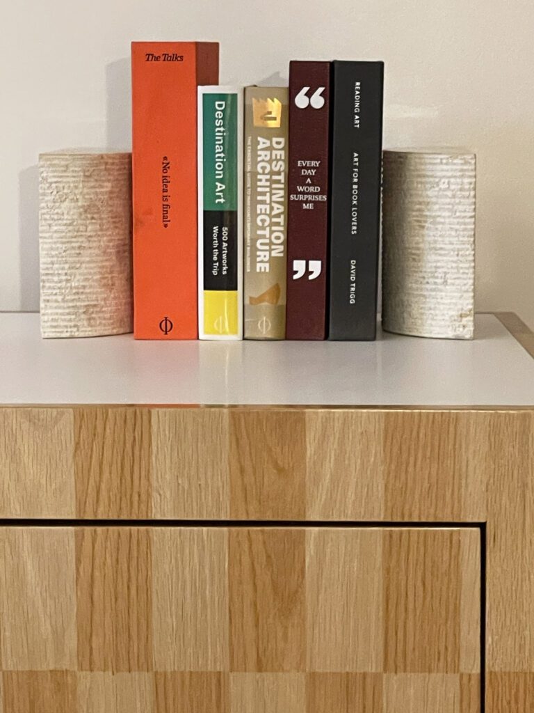 A selection of books in the guest room at Short Stories Hotel