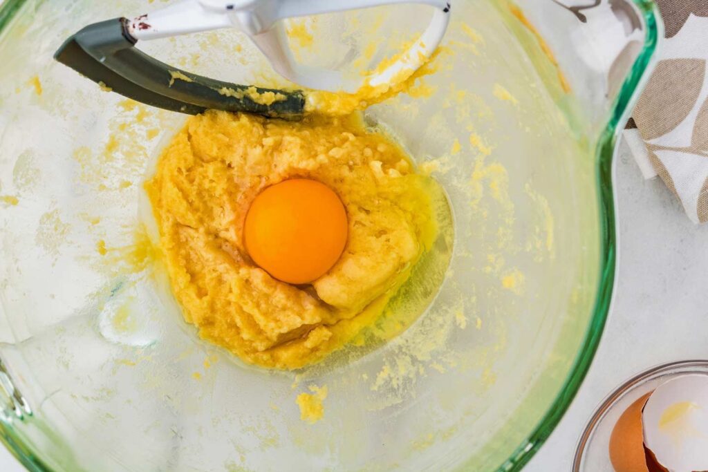 Adding eggs to the dough