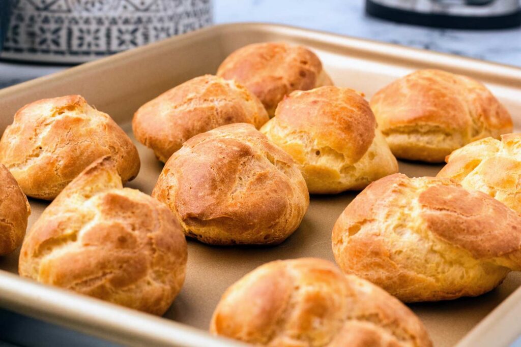 Baked cream puffs on a sheet pan