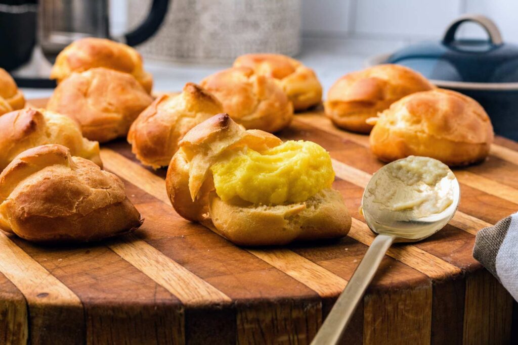 Filling the profiterole with custard