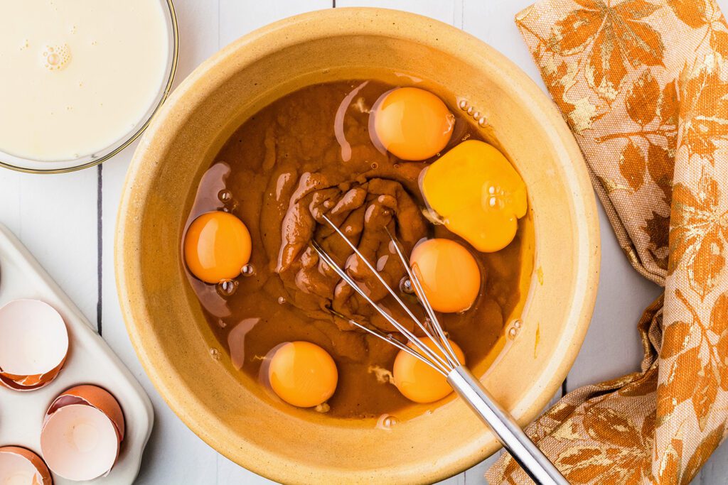 Pumpkin pie filling, condensed milk, and eggs in a large bowl