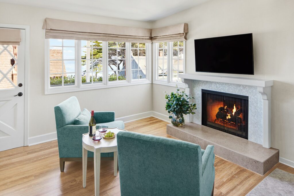 Two cozy armchairs facing a glowing fireplace